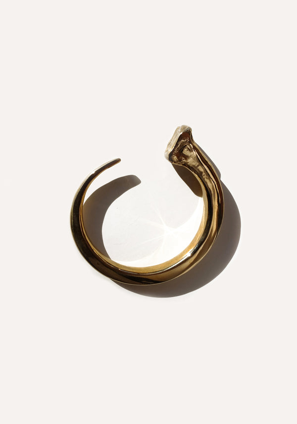 Brass Nail cuff against a white background